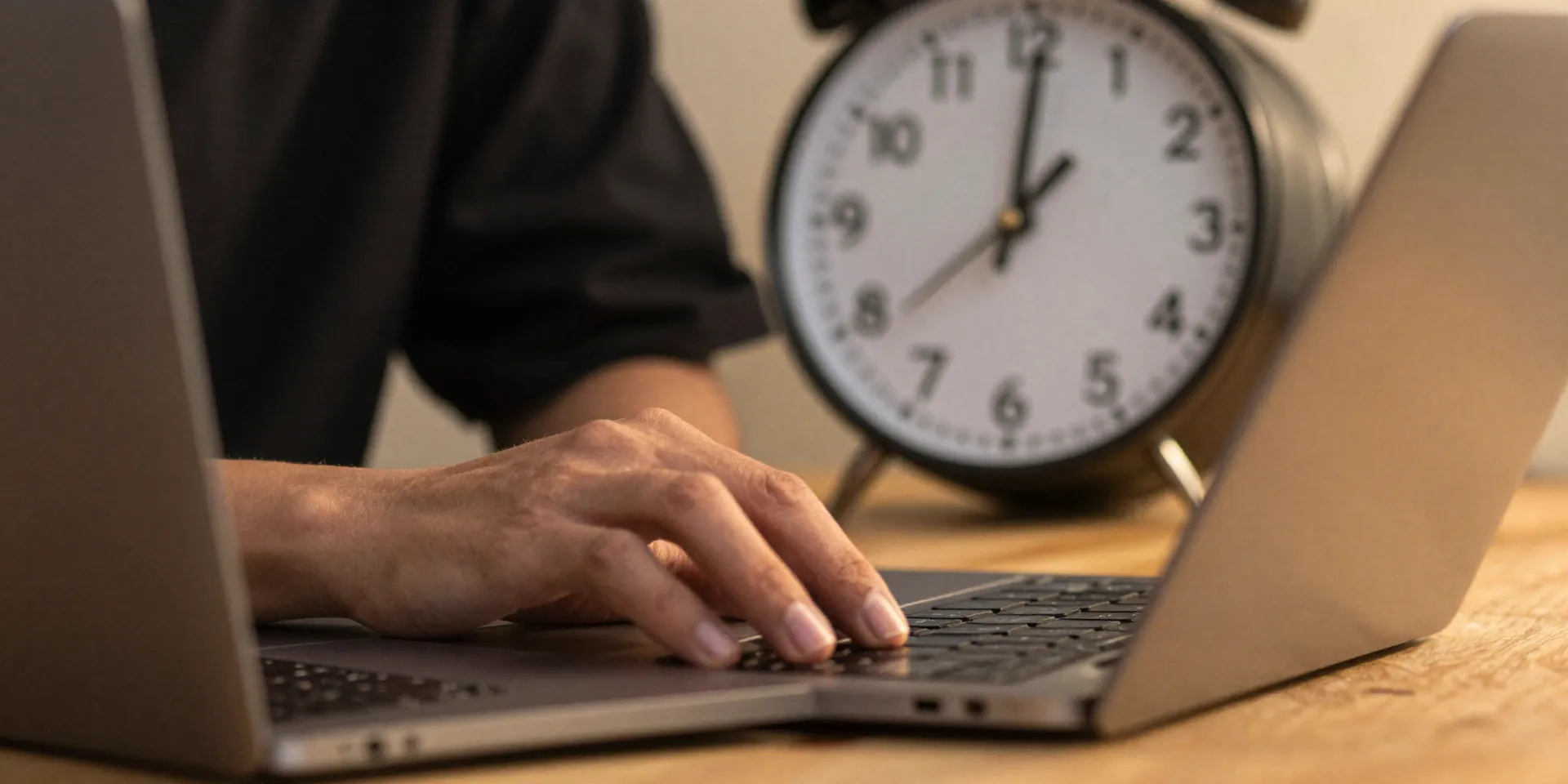 A person emphatically closing a laptop at 5 PM, with a clock in the background showing the time, warm evening light, candid shot, sense of relief --ar 16:9