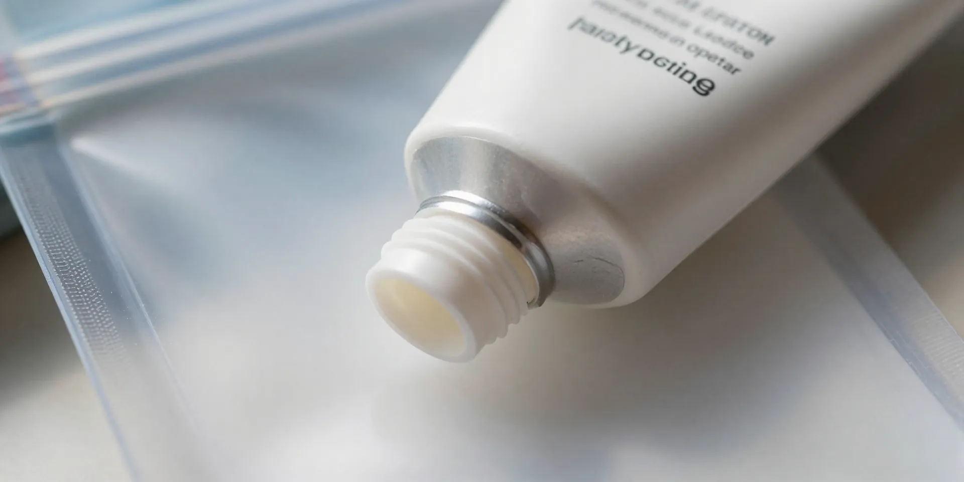 EXTREME CLOSE-UP shot of a waterproof plastic pouch being tucked inside a standard, empty tube of sunscreen. The cap is off, revealing the hidden pouch. Macro lens detail, sharp focus, bright natural light. --ar 4:5