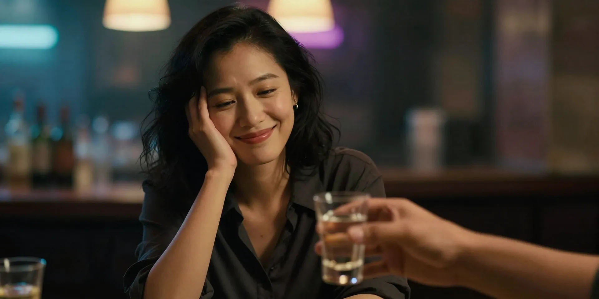 Stable Diffusion Prompt: Cinematic shot, a woman smiling politely but firmly shaking her head, a neon-lit bar background blurred, a stranger's hand offering a shot glass in the foreground, high contrast lighting, warm vs cool tones, Wong Kar-wai film aesthetic, moody and atmospheric.