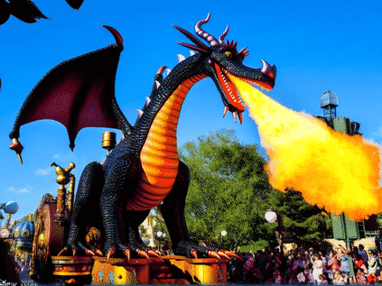 Lively scene of the Disney Festival of Fantasy Parade. A giant steampunk Maleficent dragon breathes 