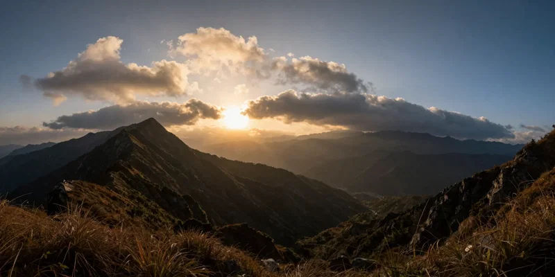 An extreme wide angle fisheye view of a mountain ridge at sunset, dramatic lighting, clouds rolling in, cinematic color grading, 8k resolution --ar 16:9