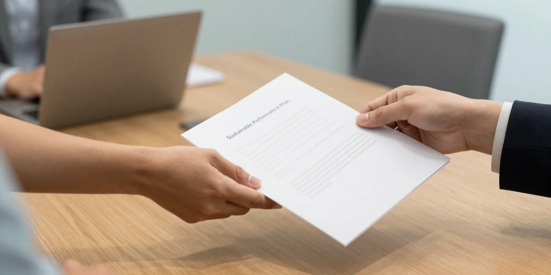 A modern, clean office meeting room. Two hands, one of an employee and one of an HR representative, are shaking over a simple, elegant document. On the document, faintly visible, are words like 'Sustainable Performance Plan.' Warm, professional atmosphere. Photorealistic. --ar 16:9
